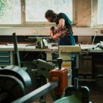 selective focus photography of man using angle grinder